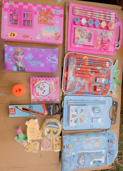 Collection of stationery items including books, pencils, and stationery sets on a wooden surface.
